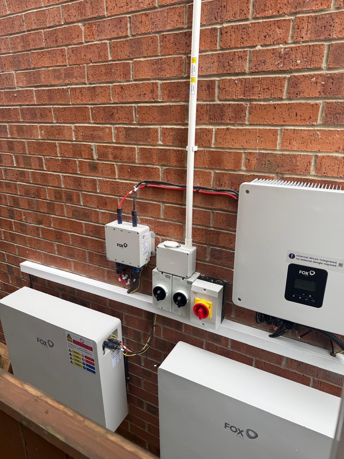Solar inverter, isolators and battery storage units mounted on an exterior wall in Beverley